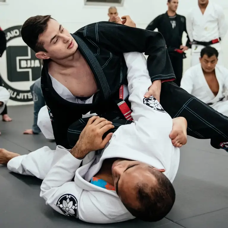 Brazilian Jiu Jitsu students sparring during training at Caio Terra Academy Long Island, wearing traditional gi uniforms.